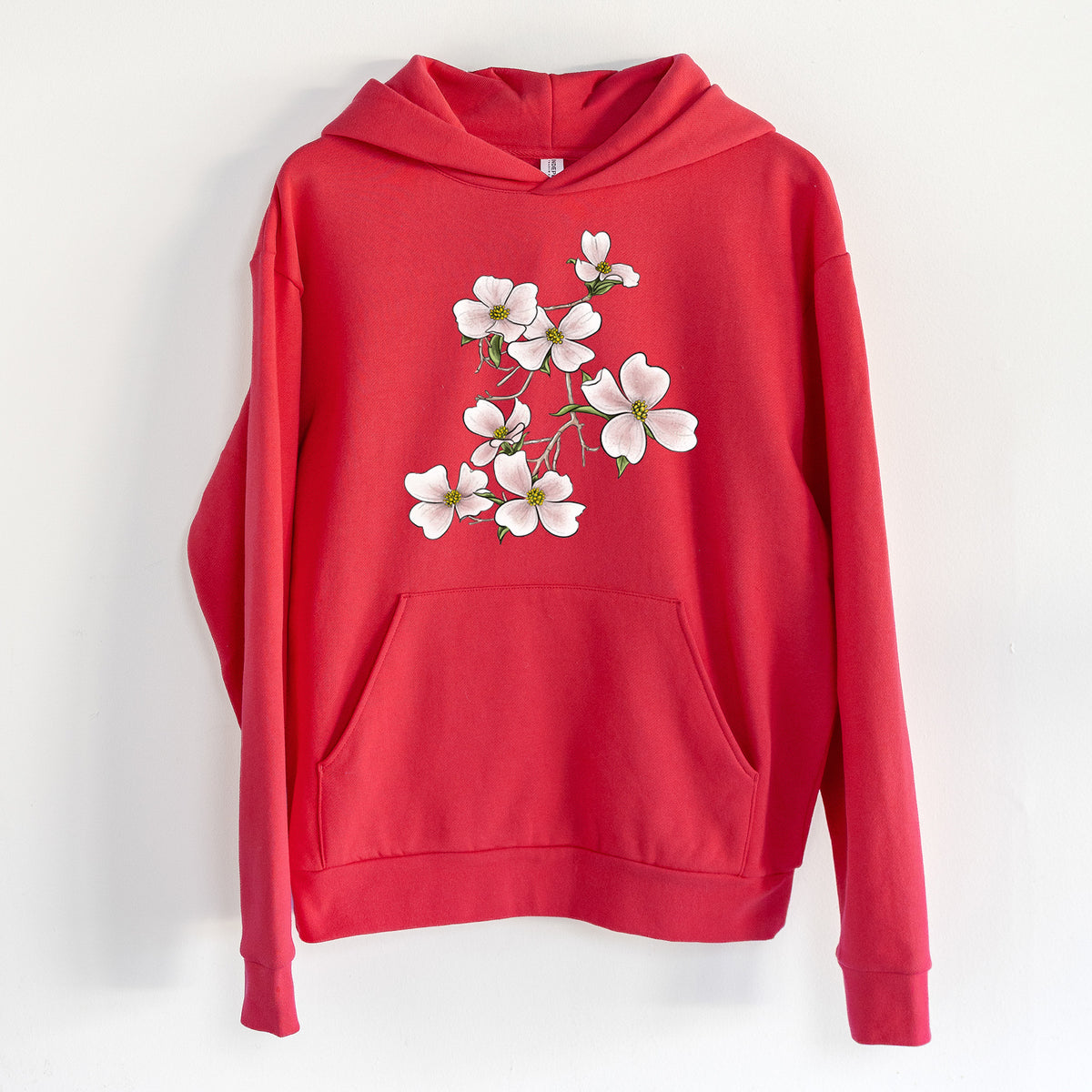 Flowering Dogwood - Cornus florida - Statement Midweight Hoodie in Cherry Red, hanging on a white wall, with a front kangaroo pocket and no drawcords.