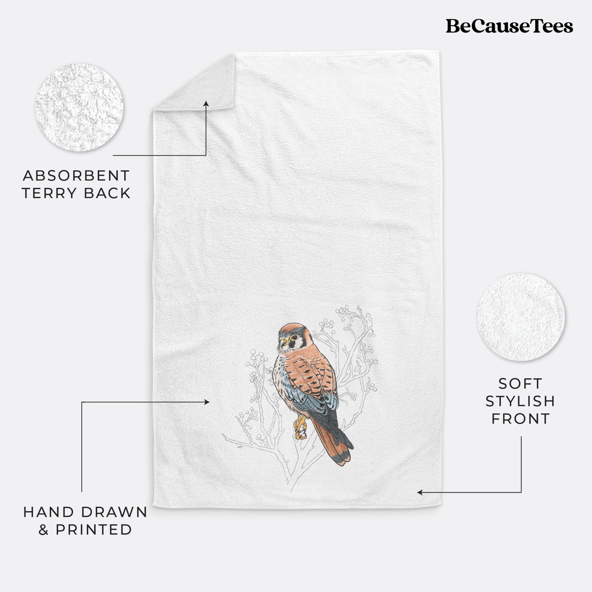 White hand towel printed with a full-color illustration of an American kestrel perched among pale branches.