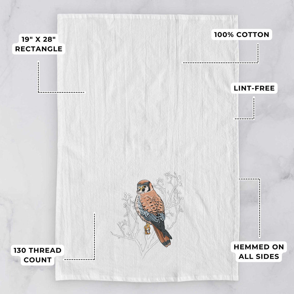 White tea towel printed with a full-color illustration of an American kestrel perched among pale branches, with feature labels: 19 by 28 inch rectangle, 100% cotton, lint-free, 130 thread count, hemmed on all sides.