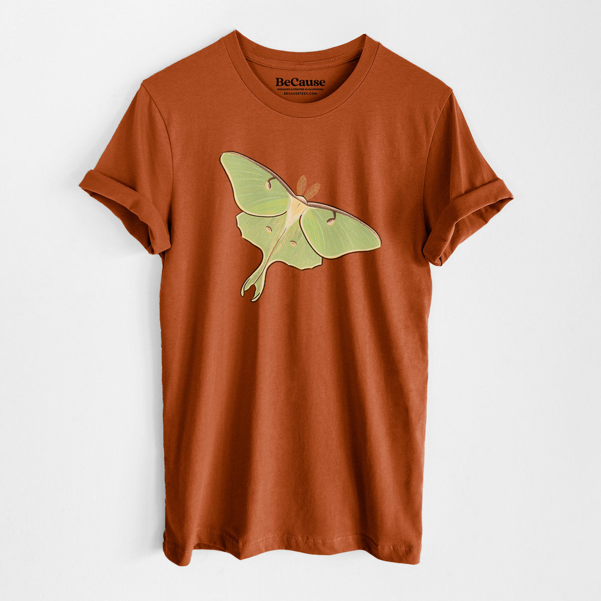 Autumn lightweight cotton t-shirt laid flat, printed with a full-color illustration of a pale green luna moth with long tails on its wings.