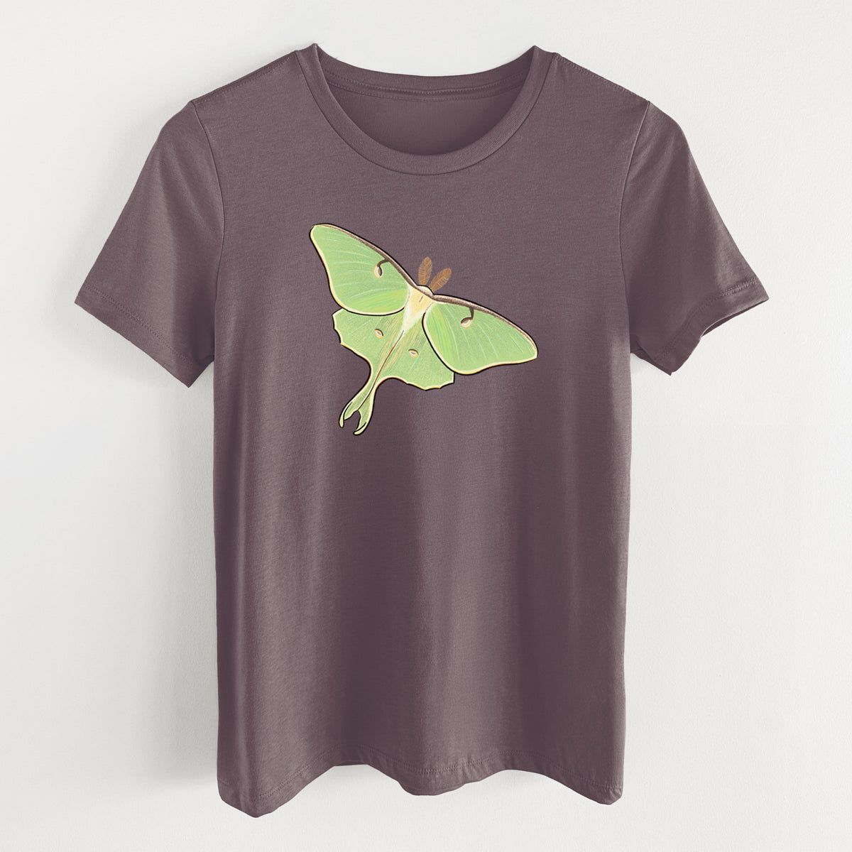 Purple storm women's relaxed fit cotton t-shirt laid flat, printed with a full-color illustration of a pale green luna moth with long tails on its wings.