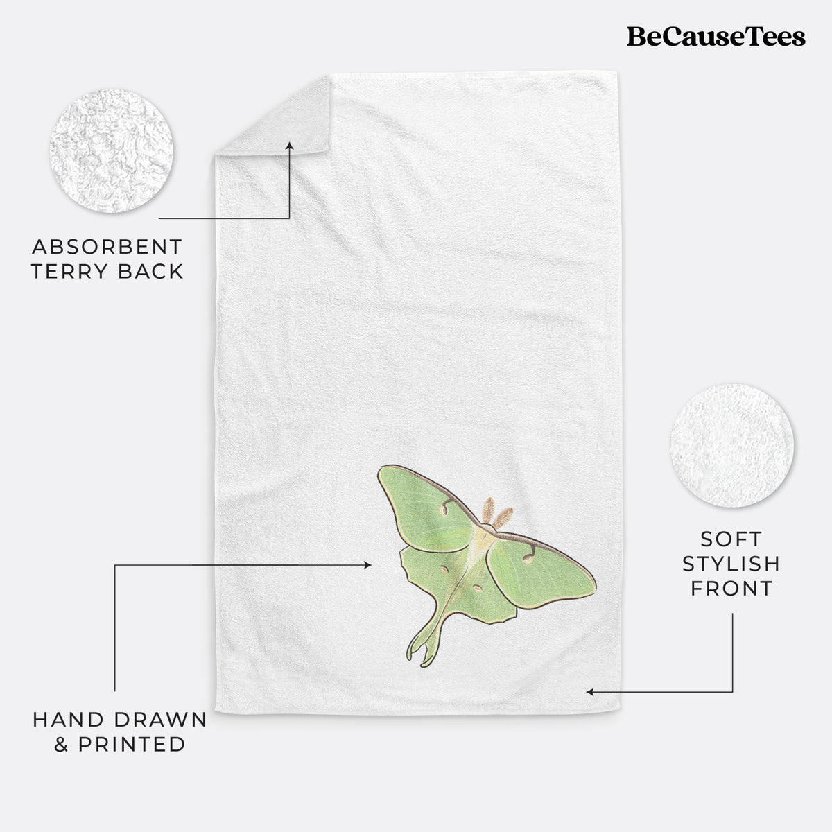 White hand towel printed with a full-color illustration of a pale green luna moth with long tails on its wings.