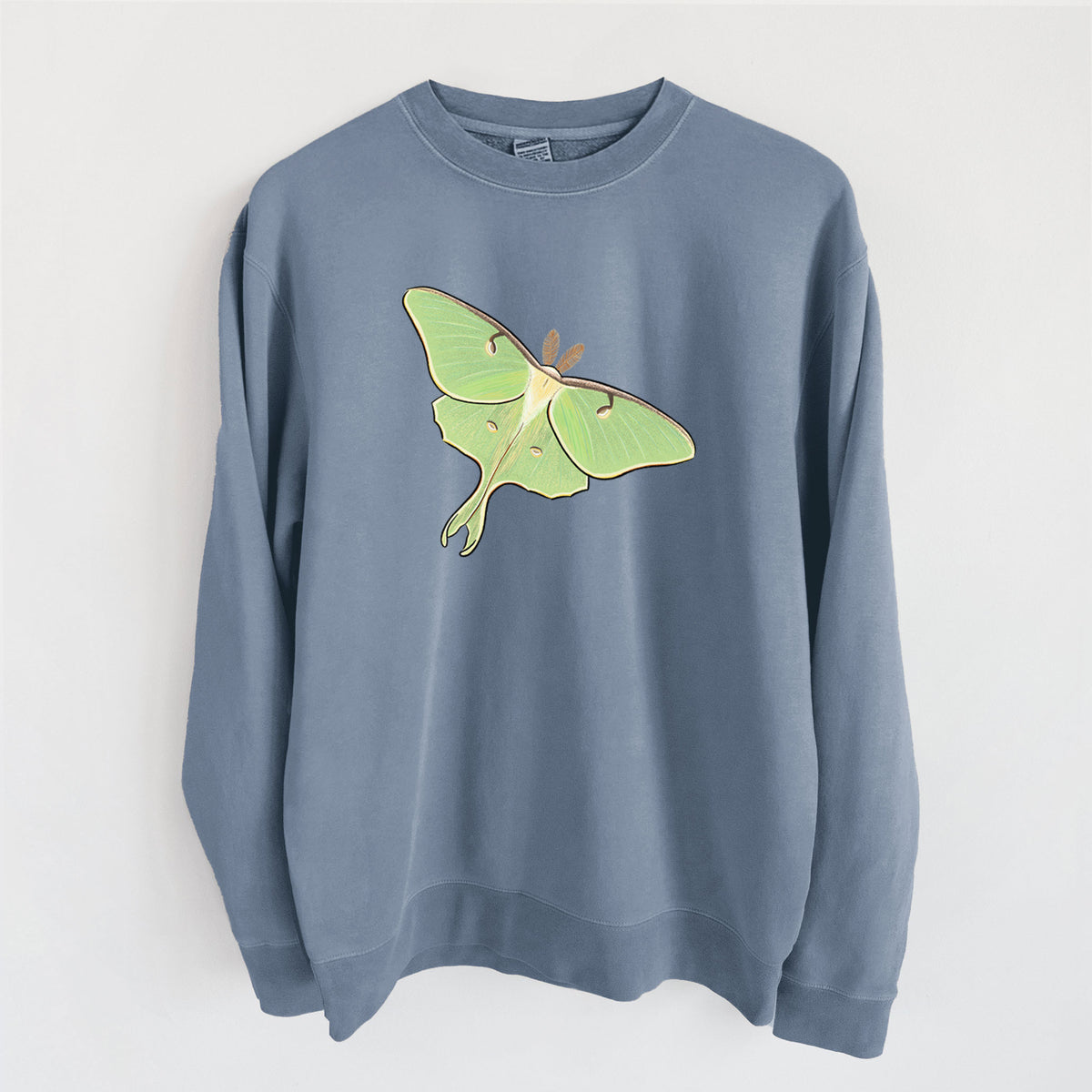 Slate blue pigment dyed crewneck sweatshirt laid flat, printed with a full-color illustration of a pale green luna moth with long tails on its wings.