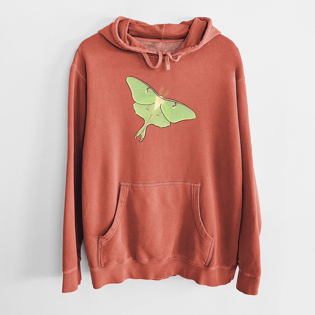 Amber orange pigment dyed hoodie laid flat, printed with a full-color illustration of a pale green luna moth with long tails on its wings.