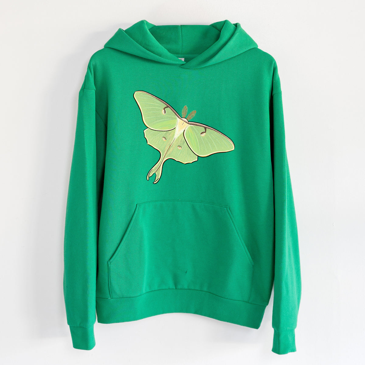 Vibrant Luna Moth - Actias luna - Statement Midweight Hoodie in Kelly Green, hanging on a white wall, with a front kangaroo pocket and no drawcords.