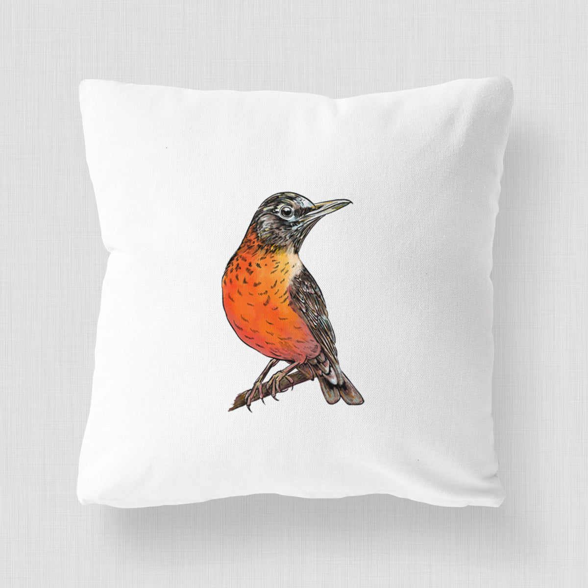 White pillow cover printed with a full-color illustration of an American robin with an orange breast perched on a branch.