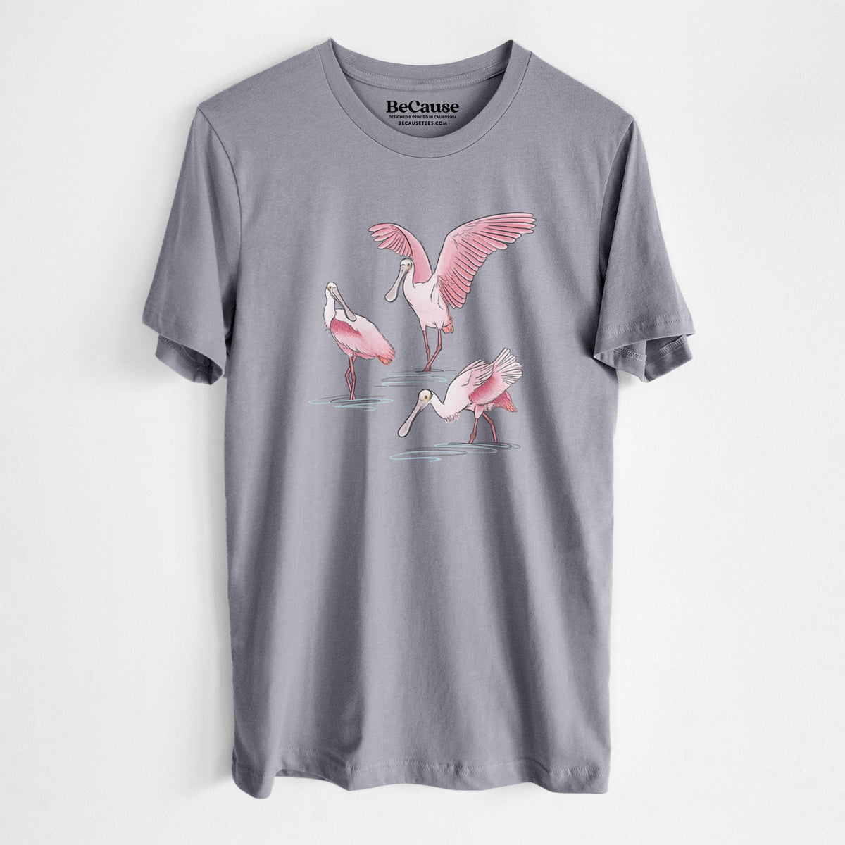 Storm grey lightweight cotton t-shirt laid flat, printed with a full-color illustration of three pink roseate spoonbills wading, one with its wings spread.