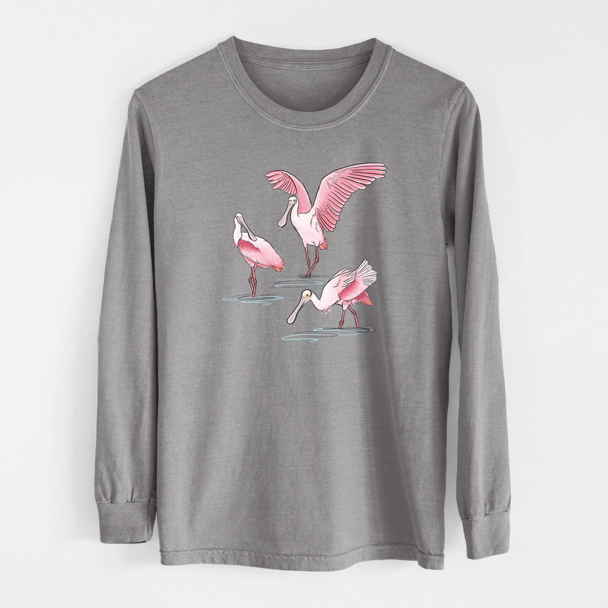 Grey Comfort Colors long sleeve shirt laid flat, printed with a full-color illustration of three pink roseate spoonbills wading, one with its wings spread.