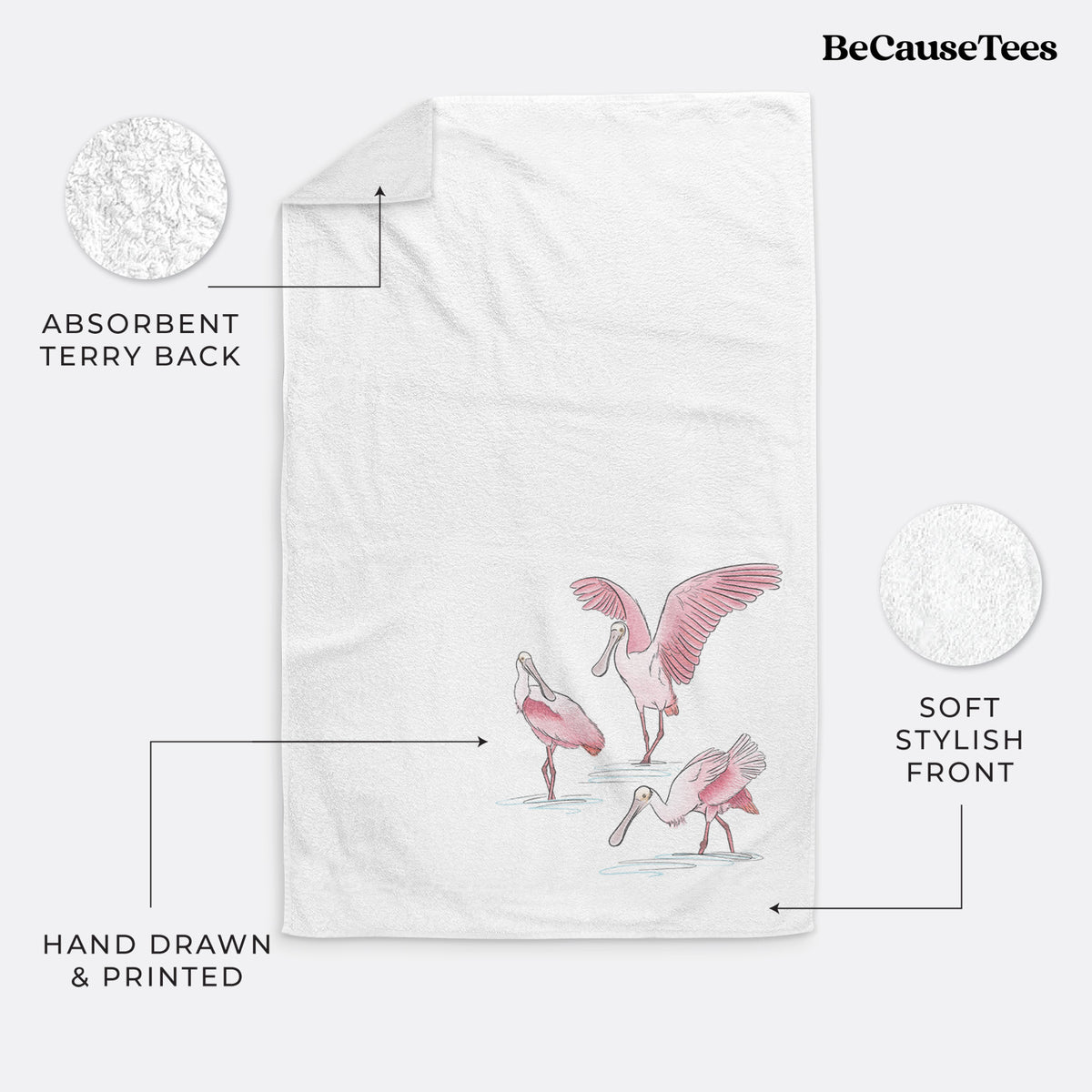 White hand towel printed with a full-color illustration of three pink roseate spoonbills wading, one with its wings spread.