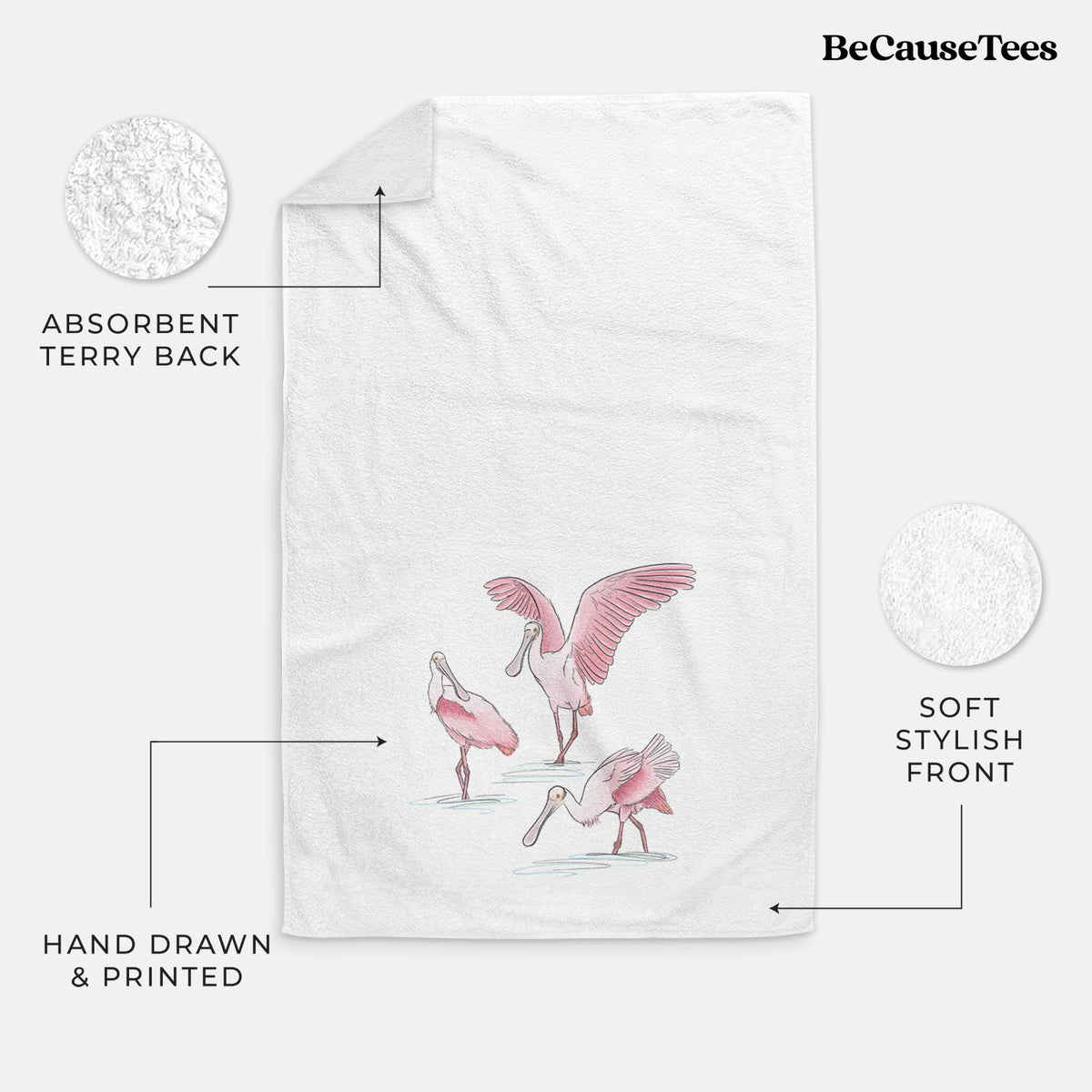 White hand towel printed with a full-color illustration of three pink roseate spoonbills wading, one with its wings spread.