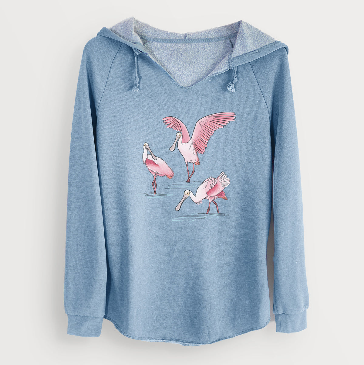 Misty blue women's Cali Wave hooded sweatshirt laid flat, printed with a full-color illustration of three pink roseate spoonbills wading, one with its wings spread.