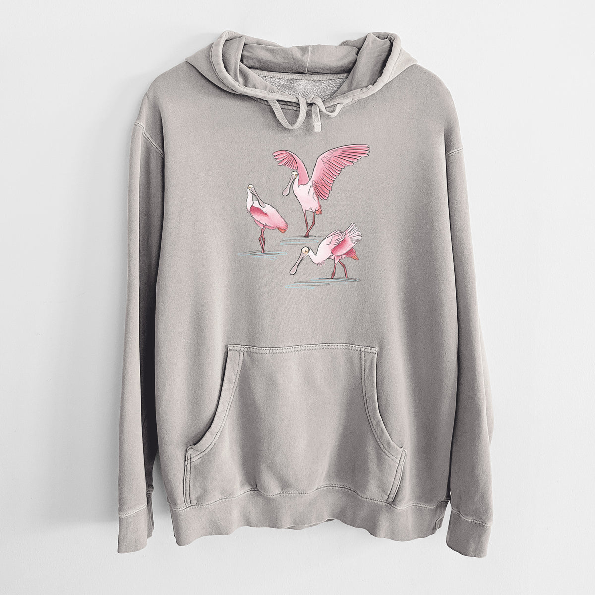 Cement grey pigment dyed hoodie laid flat, printed with a full-color illustration of three pink roseate spoonbills wading, one with its wings spread.