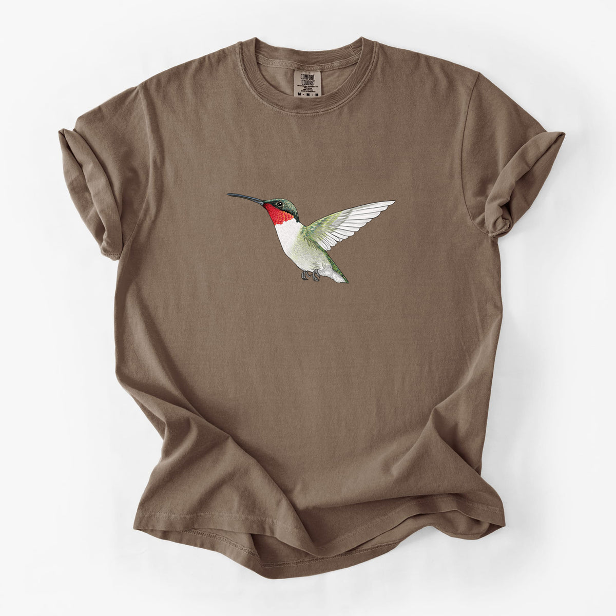 Espresso brown Comfort Colors t-shirt laid flat, printed with a full-color illustration of a ruby-throated hummingbird in flight.