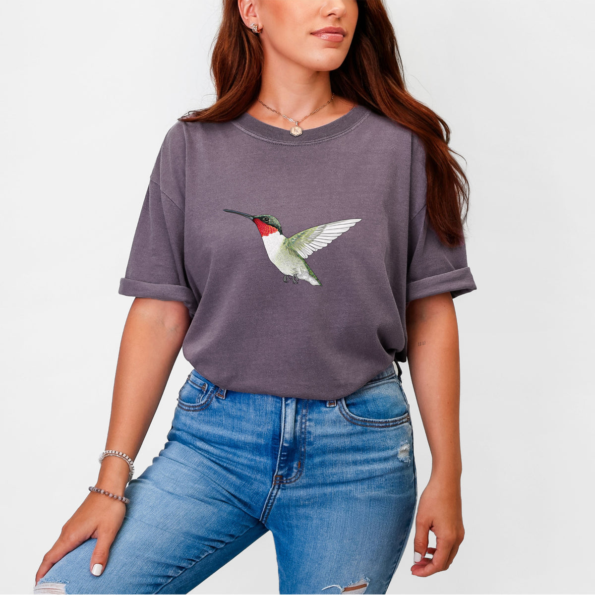 Woman wearing a Comfort Colors t-shirt printed with a full-color illustration of a ruby-throated hummingbird in flight.