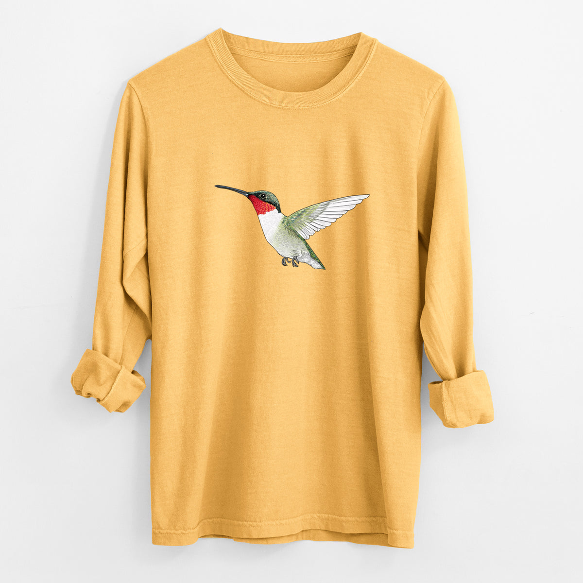 Golden wheat yellow Comfort Colors long sleeve shirt laid flat with the cuffs rolled, printed with a full-color illustration of a ruby-throated hummingbird in flight.