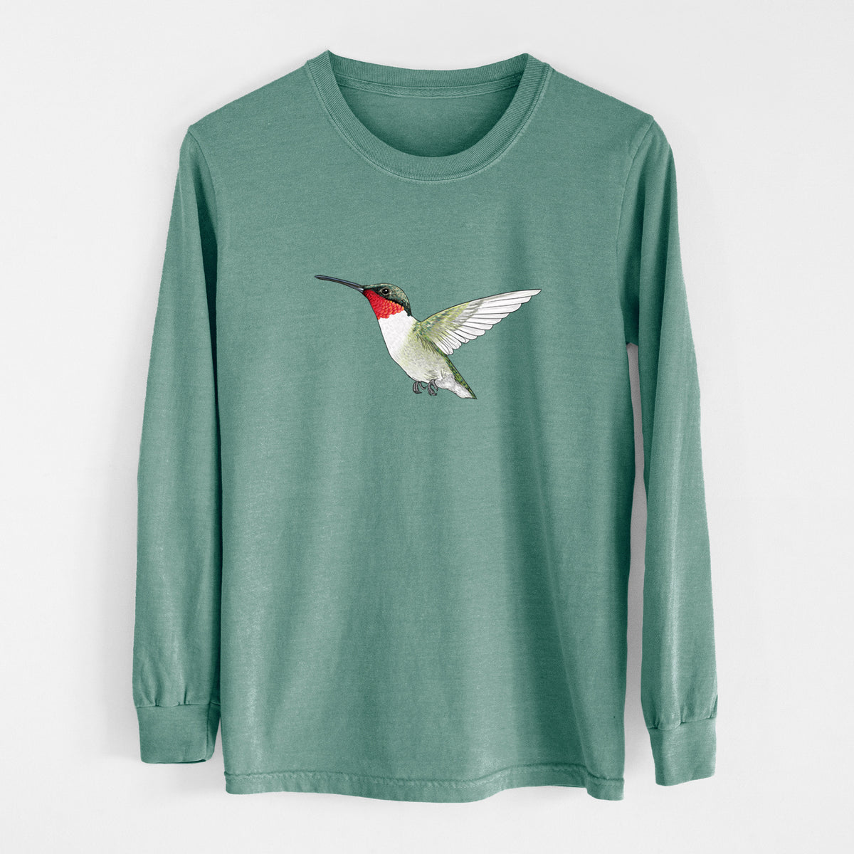 Pine green Comfort Colors long sleeve shirt laid flat, printed with a full-color illustration of a ruby-throated hummingbird in flight.