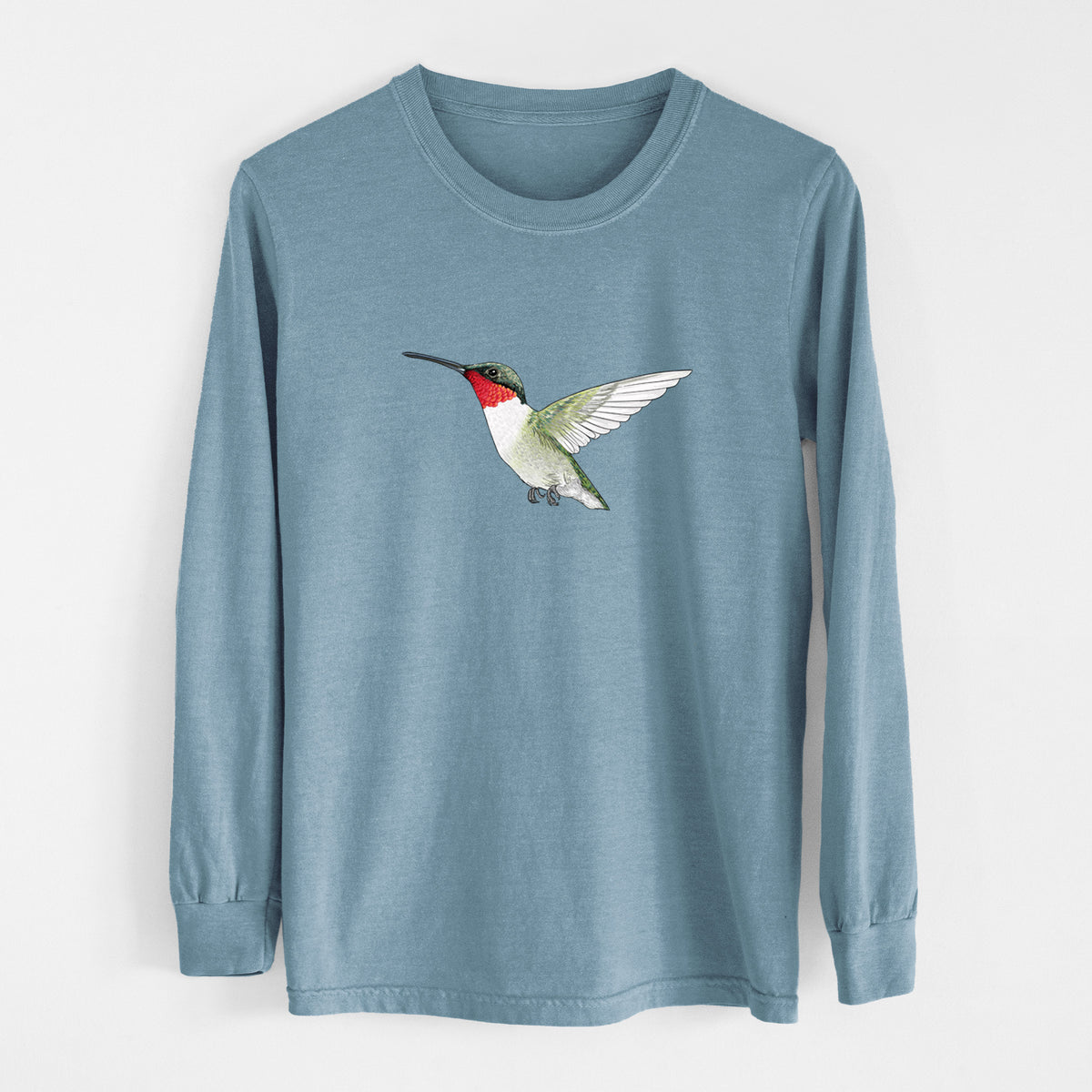 Steel blue Comfort Colors long sleeve shirt laid flat, printed with a full-color illustration of a ruby-throated hummingbird in flight.