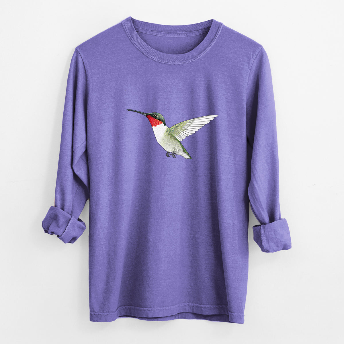 Violet purple Comfort Colors long sleeve shirt laid flat with the cuffs rolled, printed with a full-color illustration of a ruby-throated hummingbird in flight.