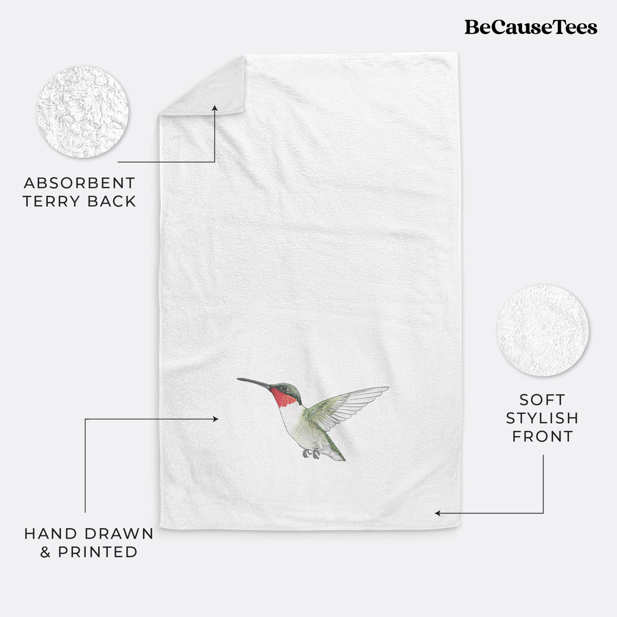 White hand towel printed with a full-color illustration of a ruby-throated hummingbird in flight.
