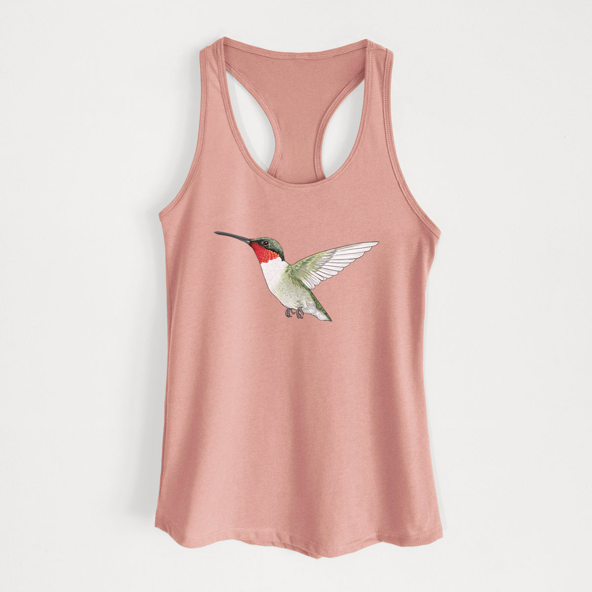 Desert pink women's racerback tank top laid flat, printed with a full-color illustration of a ruby-throated hummingbird in flight.