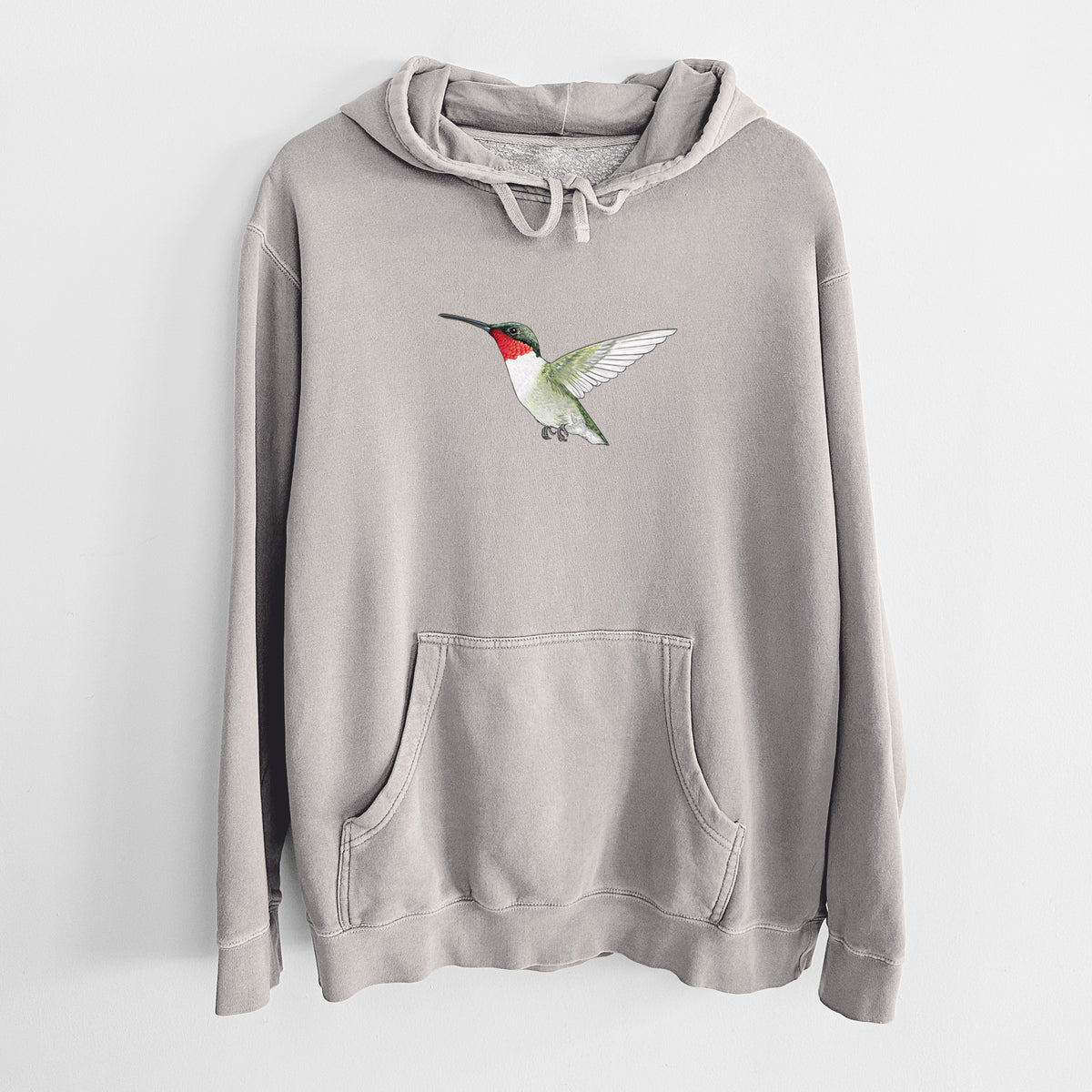 Cement grey pigment dyed hoodie laid flat, printed with a full-color illustration of a ruby-throated hummingbird in flight.