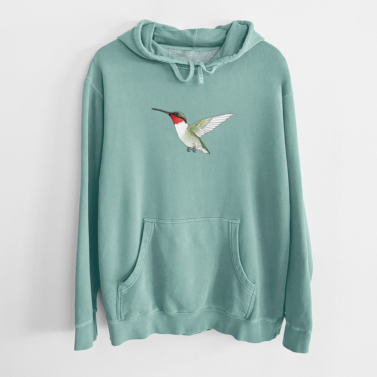 Mint green pigment dyed hoodie laid flat, printed with a full-color illustration of a ruby-throated hummingbird in flight.