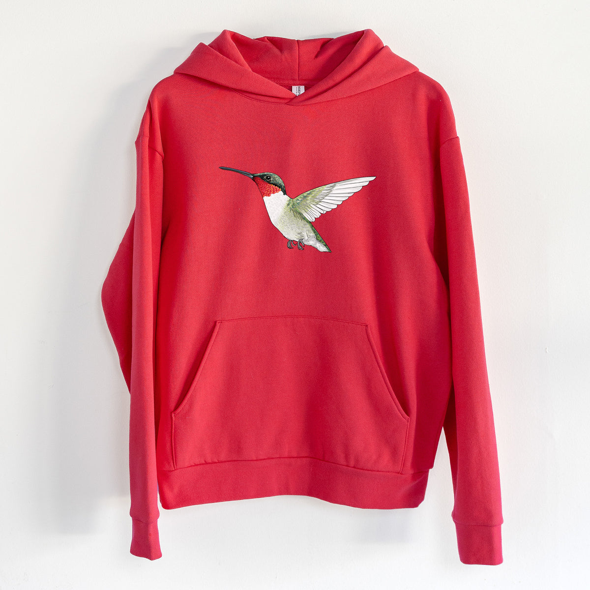 Vibrant Ruby-throated Hummingbird - Archilochus colubris - Statement Midweight Hoodie in Cherry Red, hanging on a white wall, with a front kangaroo pocket and no drawcords.