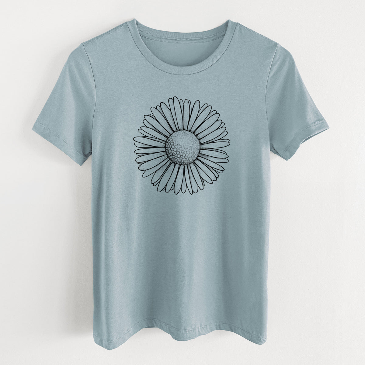 Vintage denim women's relaxed fit cotton t-shirt laid flat, printed with a detailed black ink line drawing of a single common daisy flower.