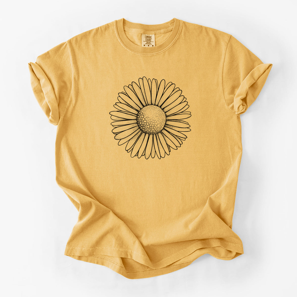 Golden wheat yellow Comfort Colors t-shirt laid flat, printed with a detailed black ink line drawing of a single common daisy flower.