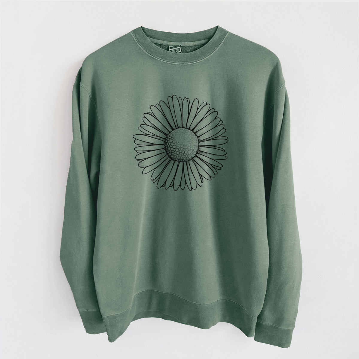 Alpine green pigment dyed crewneck sweatshirt laid flat, printed with a detailed black ink line drawing of a single common daisy flower.
