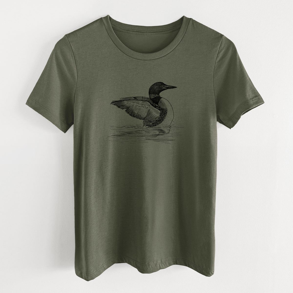 Military green women's relaxed fit cotton t-shirt laid flat, printed with a detailed black ink sketch of a common loon floating on rippling water.