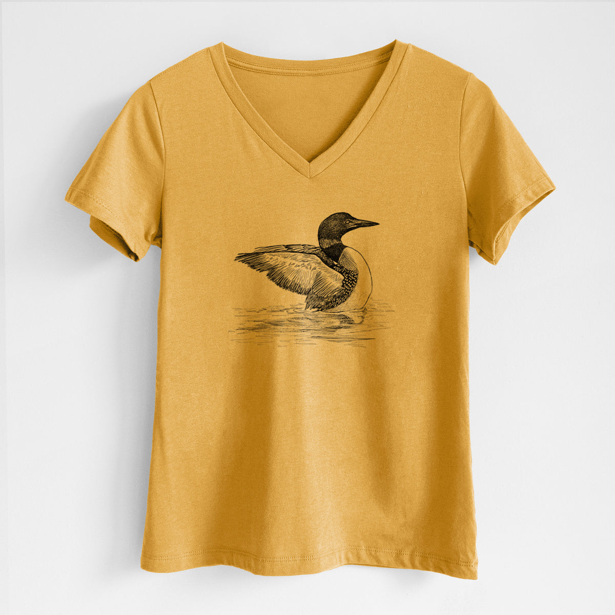 Honeycomb yellow women's relaxed fit cotton V-neck t-shirt laid flat, printed with a detailed black ink sketch of a common loon floating on rippling water.