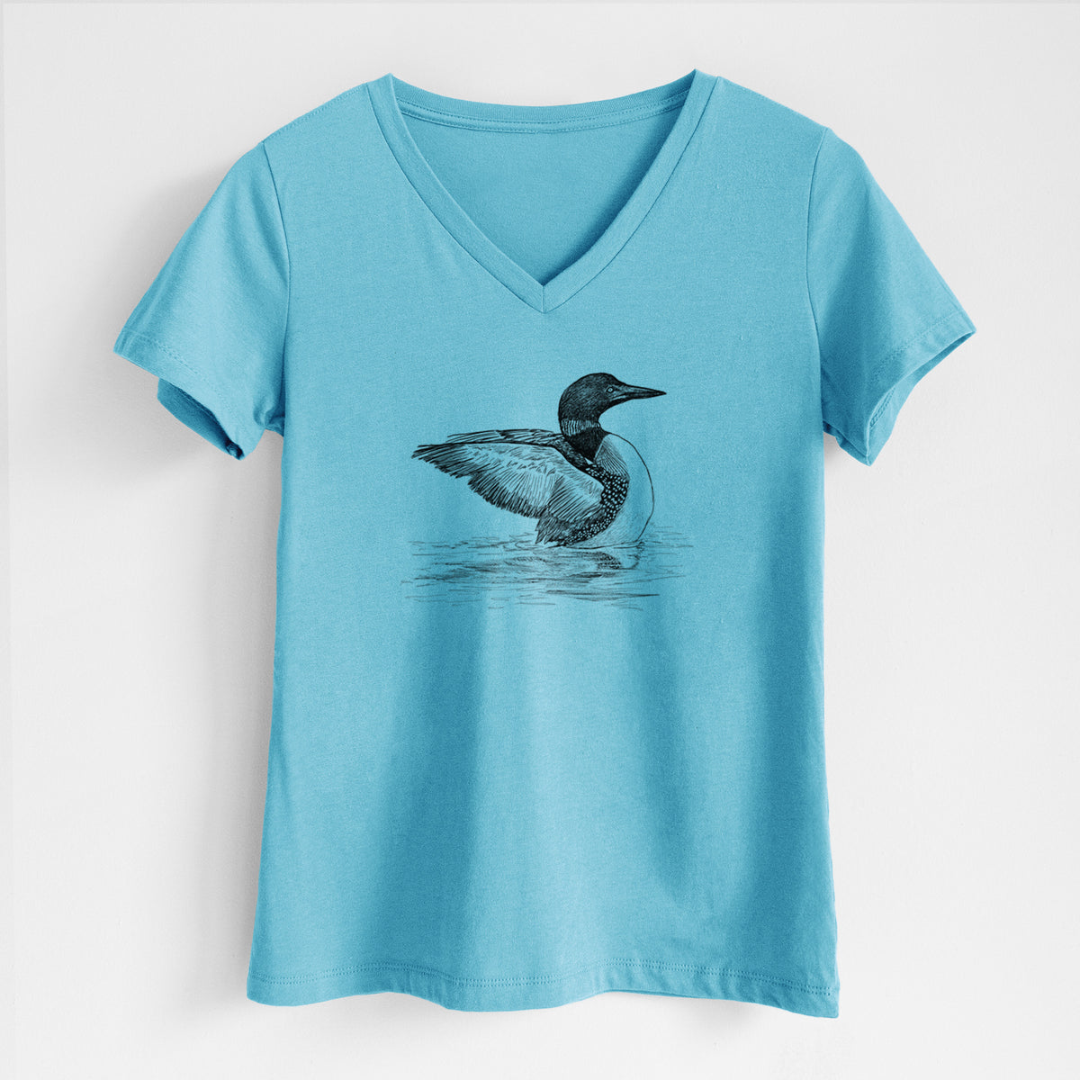 Turquoise women's relaxed fit cotton V-neck t-shirt laid flat, printed with a detailed black ink sketch of a common loon floating on rippling water.