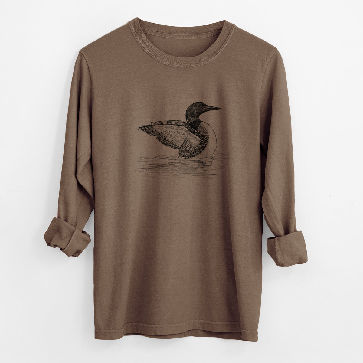 Espresso brown Comfort Colors long sleeve shirt laid flat with the cuffs rolled, printed with a detailed black ink sketch of a common loon floating on rippling water.
