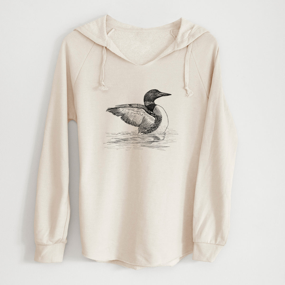 Bone cream women's Cali Wave hooded sweatshirt laid flat, printed with a detailed black ink sketch of a common loon floating on rippling water.