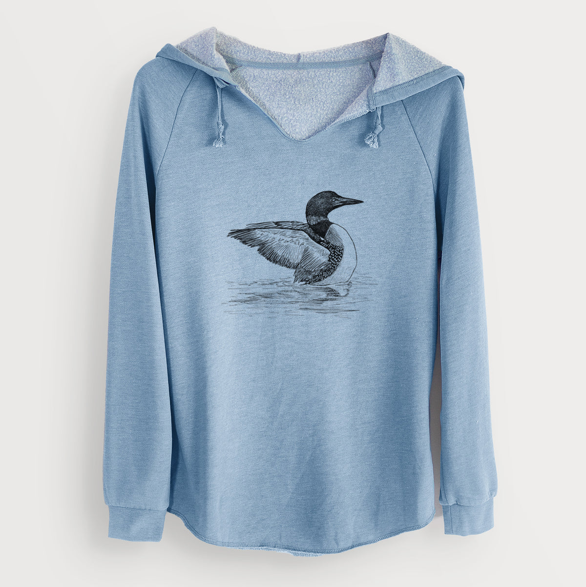 Misty blue women's Cali Wave hooded sweatshirt laid flat, printed with a detailed black ink sketch of a common loon floating on rippling water.