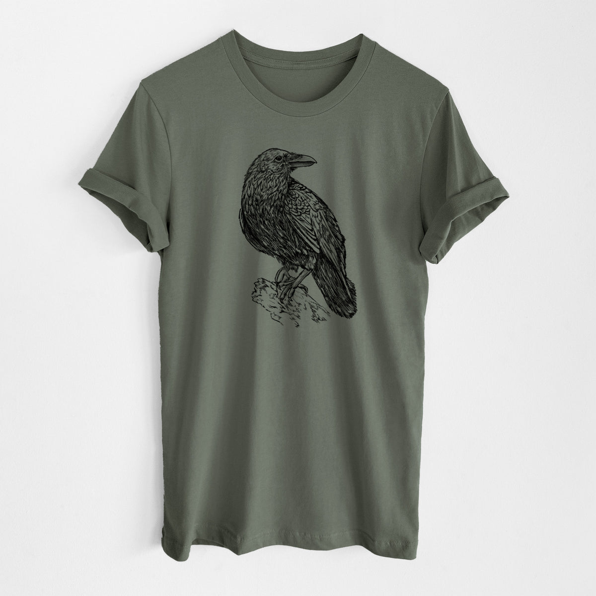 Military green lightweight cotton t-shirt laid flat, printed with a detailed black ink sketch of a common raven perched on a rock.