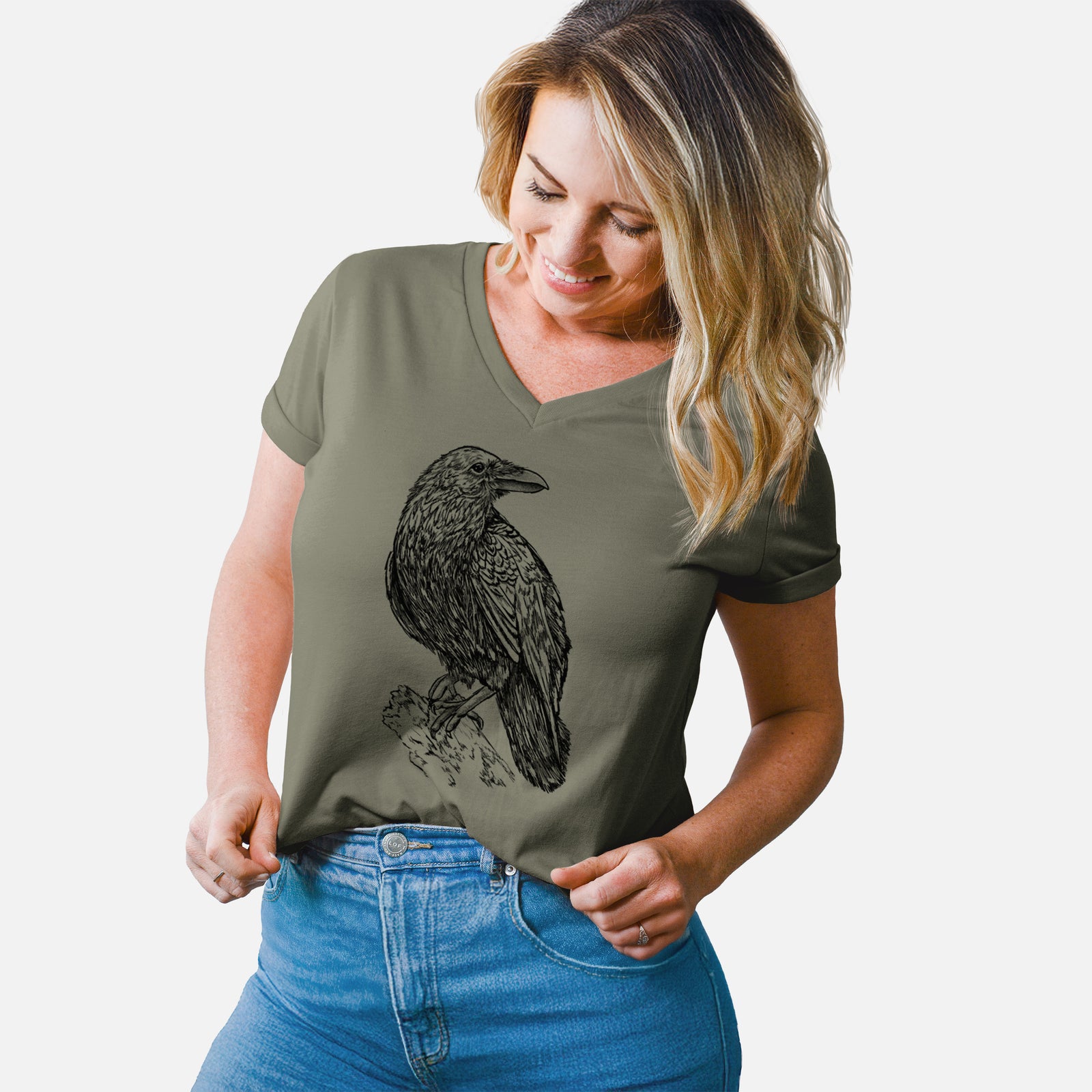 Turquoise women's relaxed fit cotton V-neck t-shirt laid flat, printed with a detailed black ink sketch of a common raven perched on a rock.
