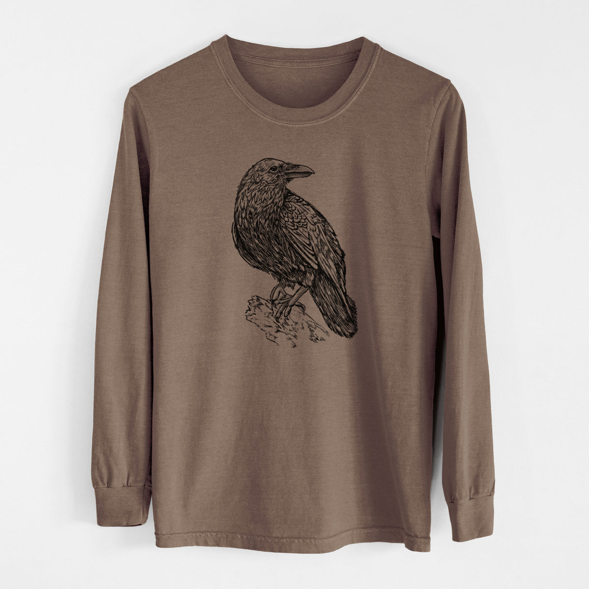Espresso brown Comfort Colors long sleeve shirt laid flat, printed with a detailed black ink sketch of a common raven perched on a rock.