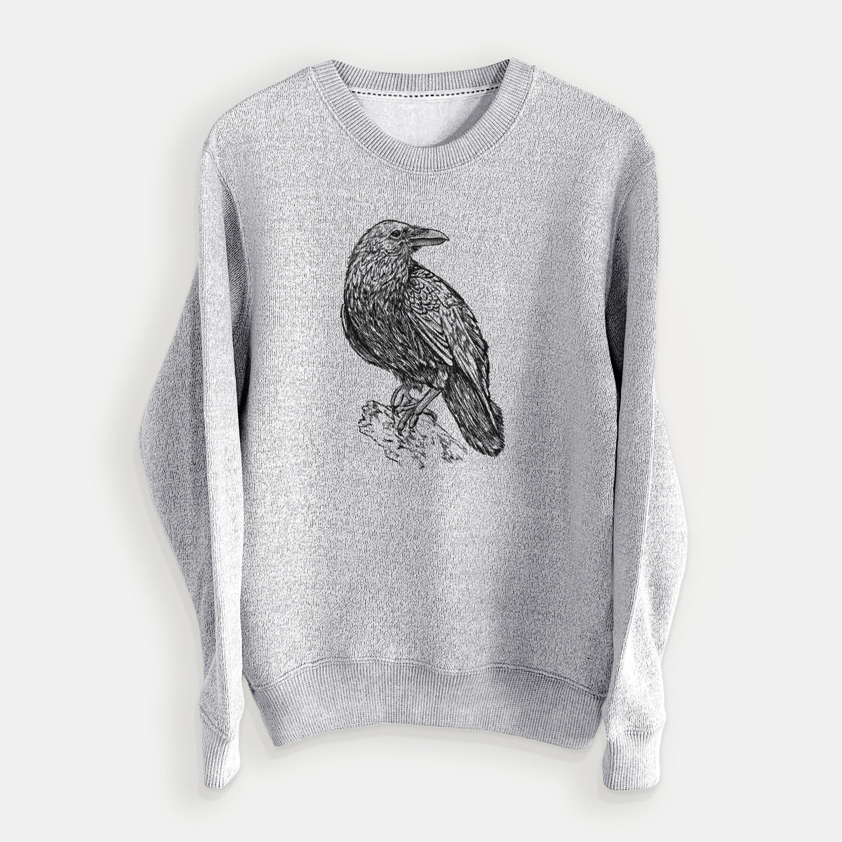 Salt and pepper knit sweatshirt laid flat, printed with a detailed black ink sketch of a common raven perched on a rock.
