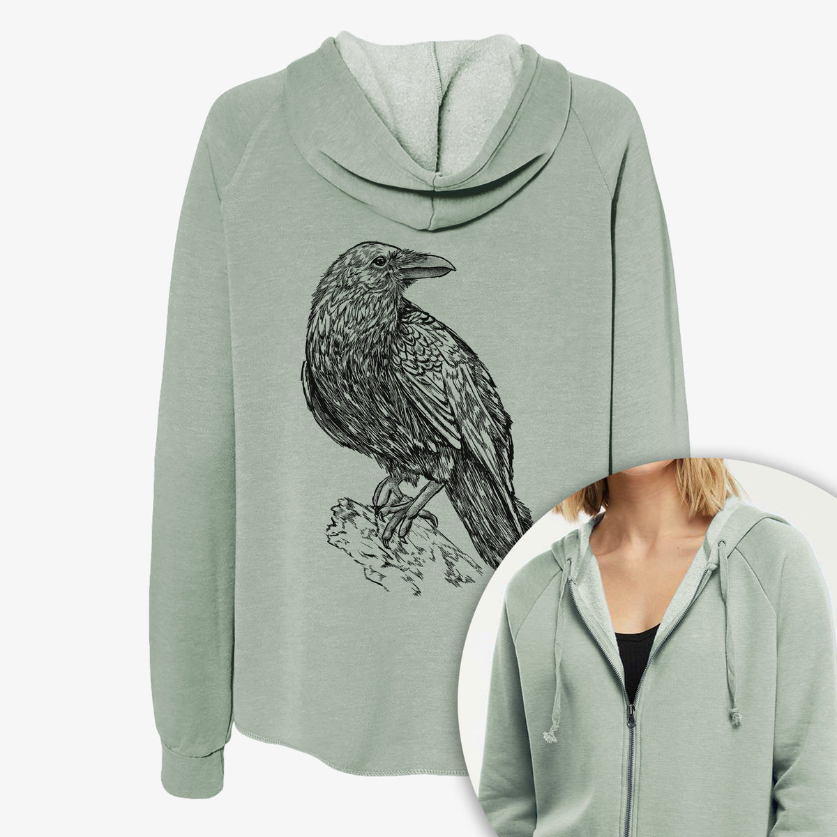 Women's Cali Wave zip-up sweatshirt printed with a detailed black ink sketch of a common raven perched on a rock, with a close-up of the zipper.
