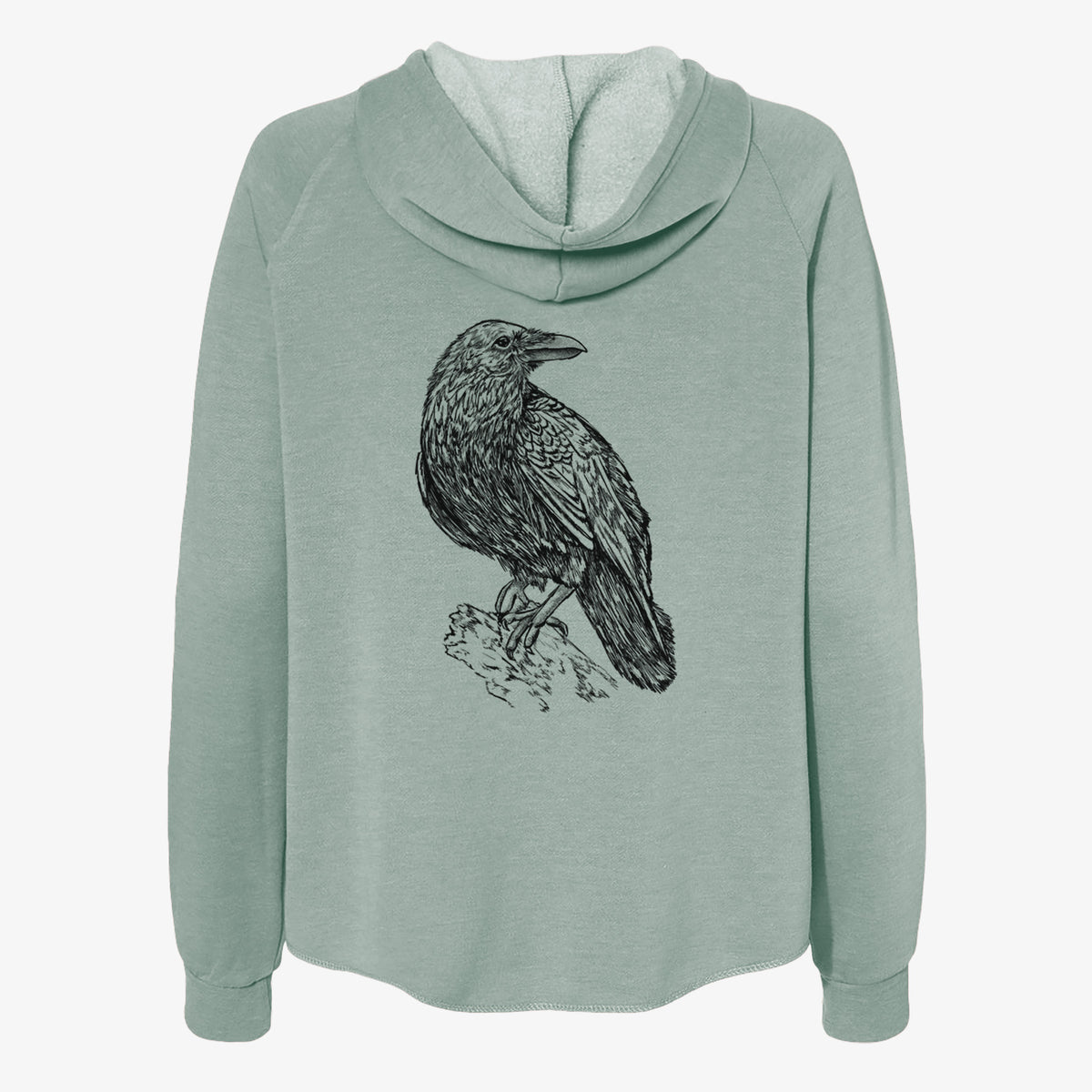 Sage green women's Cali Wave zip-up sweatshirt laid flat, printed with a detailed black ink sketch of a common raven perched on a rock.