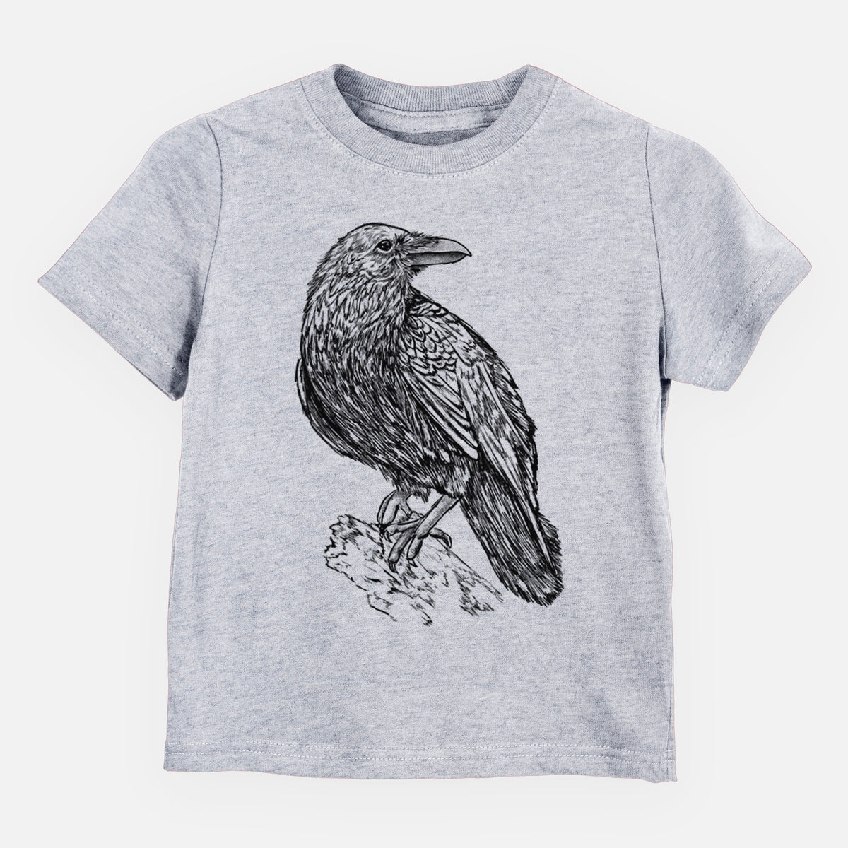 Heather grey toddler t-shirt laid flat, printed with a detailed black ink sketch of a common raven perched on a rock.