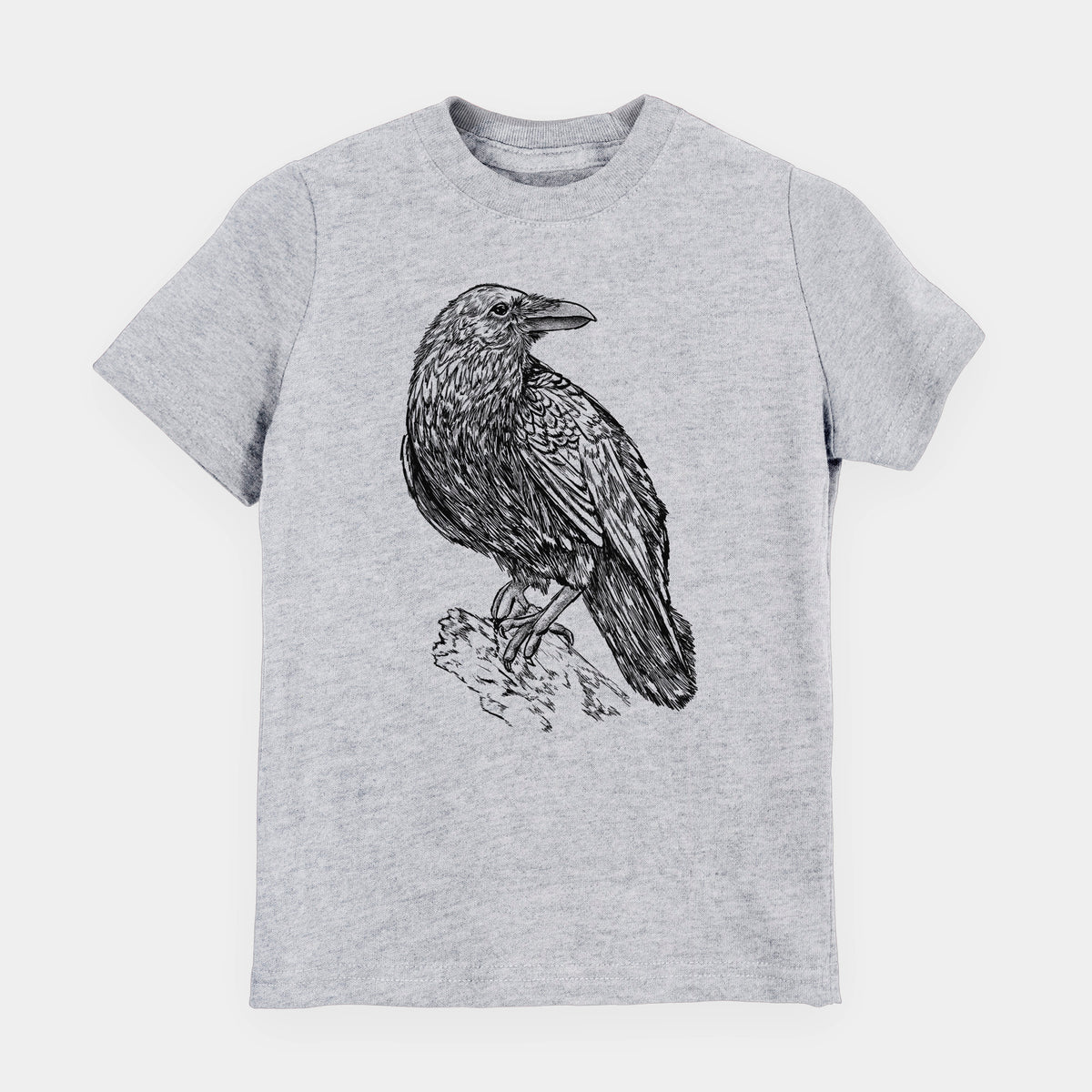 Heather grey youth t-shirt laid flat, printed with a detailed black ink sketch of a common raven perched on a rock.
