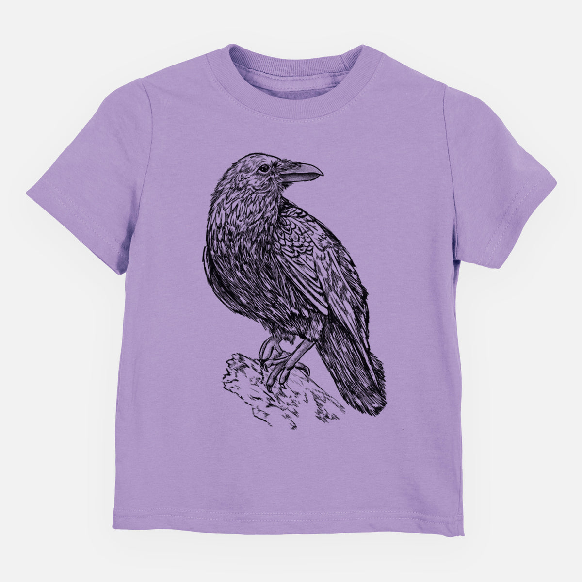 Lavender toddler t-shirt laid flat, printed with a detailed black ink sketch of a common raven perched on a rock.