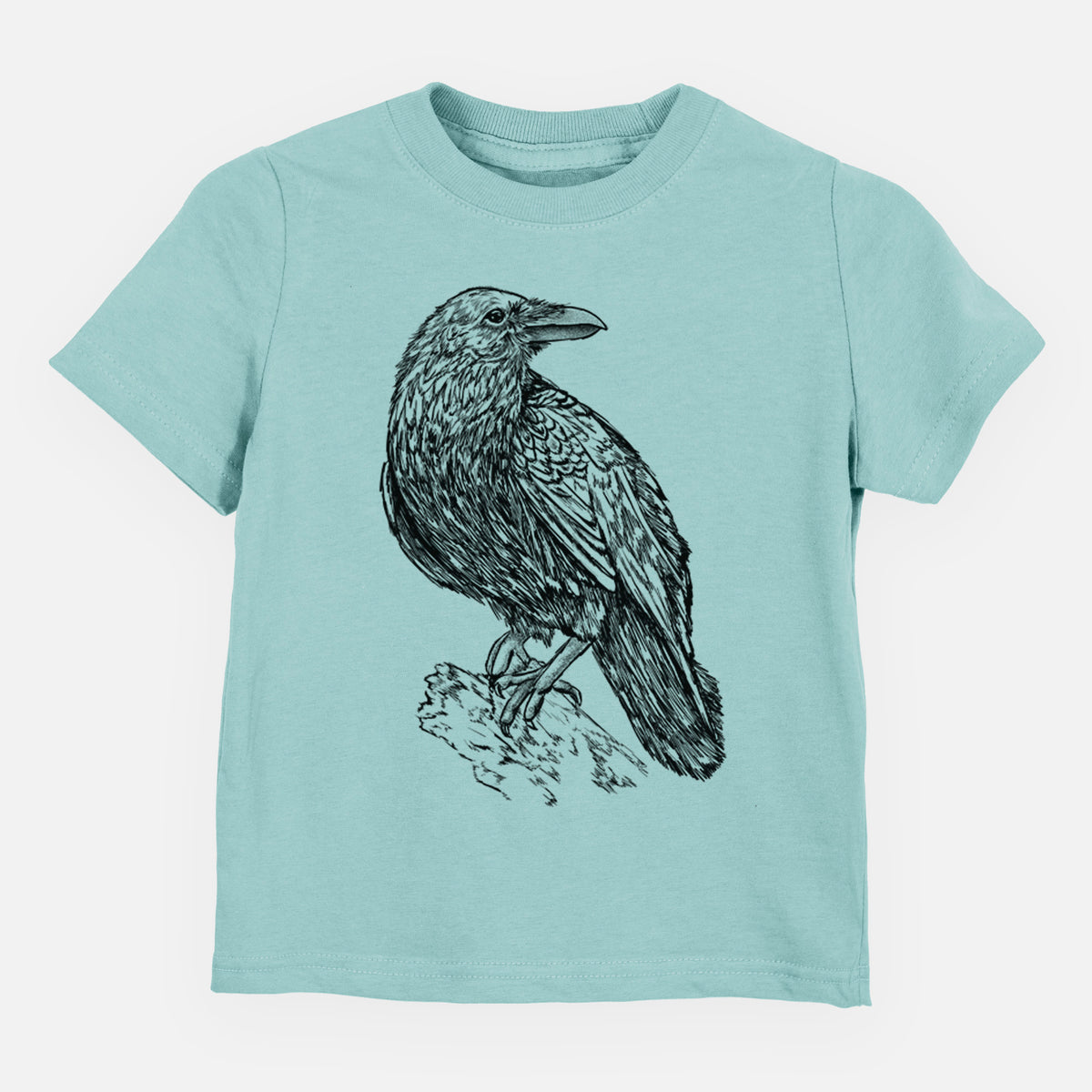 Saltwater toddler t-shirt laid flat, printed with a detailed black ink sketch of a common raven perched on a rock.