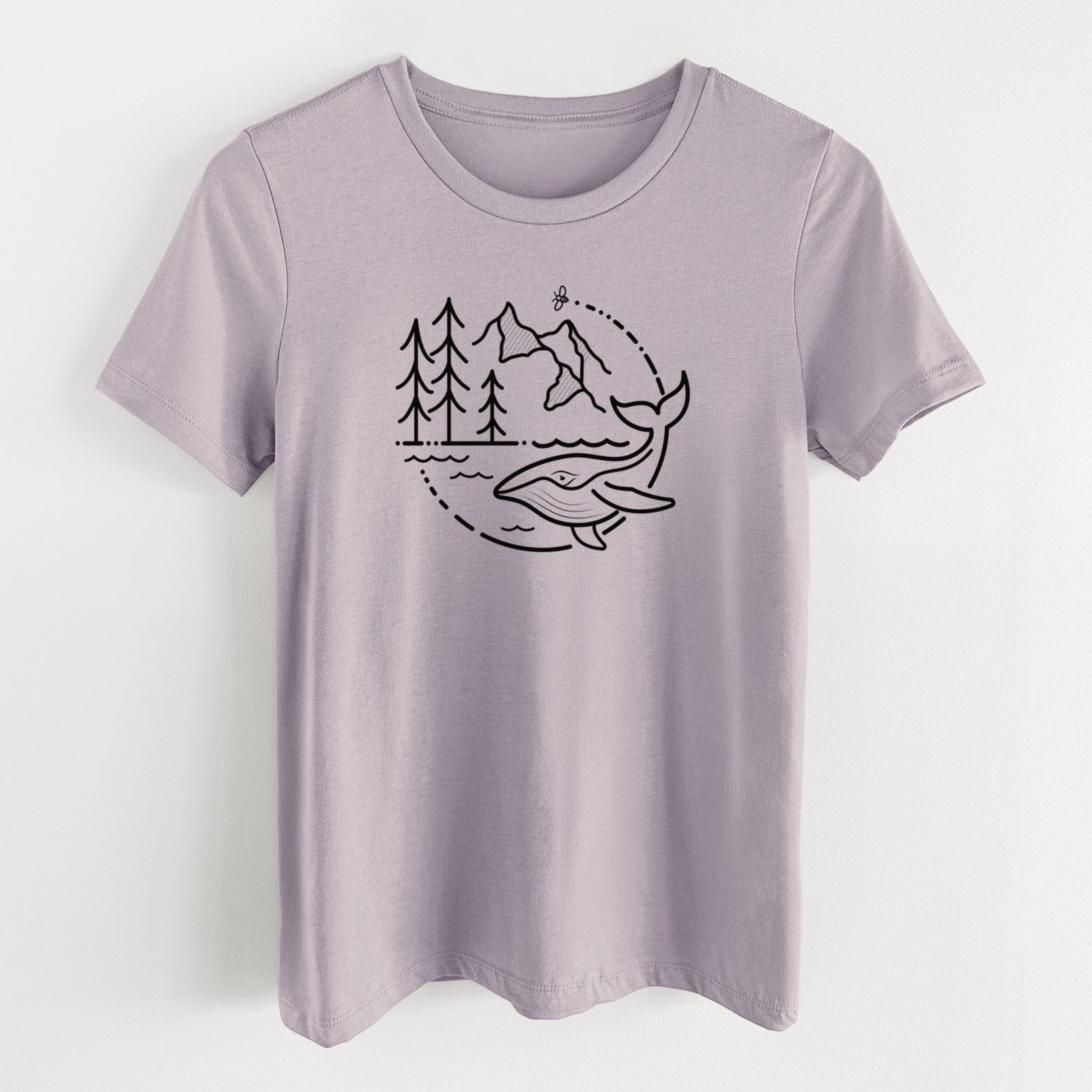 Light violet women's relaxed fit cotton t-shirt laid flat, printed with a black line art circle connecting a mountain range, pine trees, a bee and a whale swimming in ocean waves.