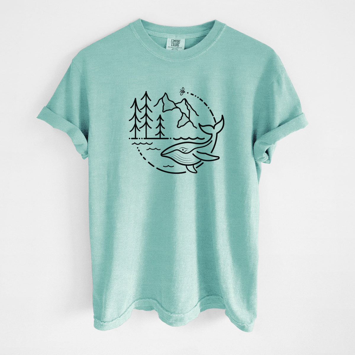 Chalky mint Comfort Colors t-shirt laid flat, printed with a black line art circle connecting a mountain range, pine trees, a bee and a whale swimming in ocean waves.