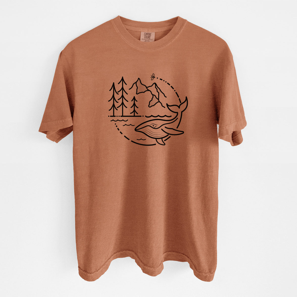 Yam burnt orange Comfort Colors t-shirt laid flat, printed with a black line art circle connecting a mountain range, pine trees, a bee and a whale swimming in ocean waves.