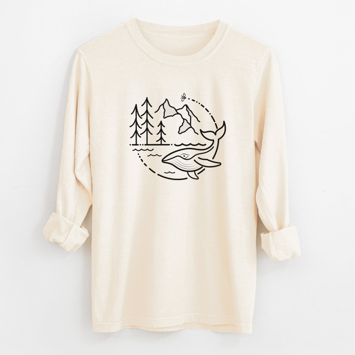 Ivory Comfort Colors long sleeve shirt laid flat with the cuffs rolled, printed with a black line art circle connecting a mountain range, pine trees, a bee and a whale swimming in ocean waves.